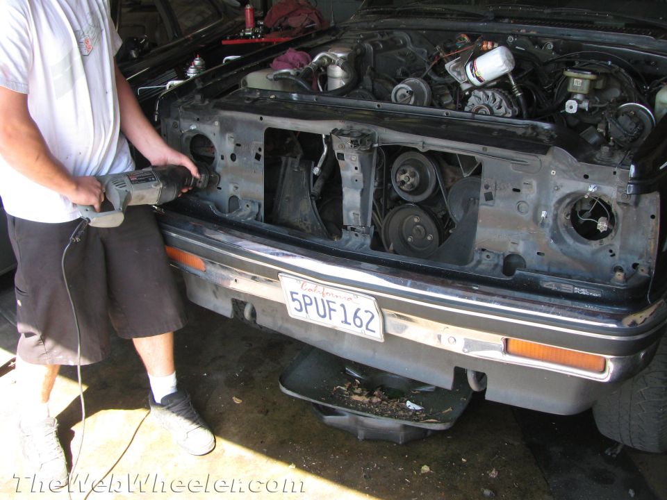 1987 Suzuki Samurai front end with engine exposed, person using reciprocating saw