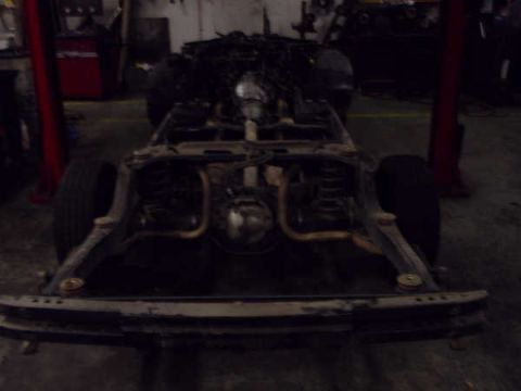 1996 Ford Crown Victoria - The undercarriage of a car is shown, with suspension and exhaust components clearly visible.
