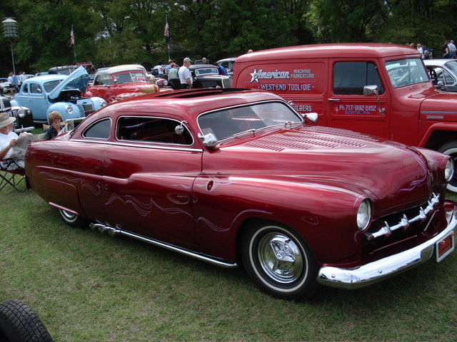 Red customized coupe with pinstripes and a sunroof