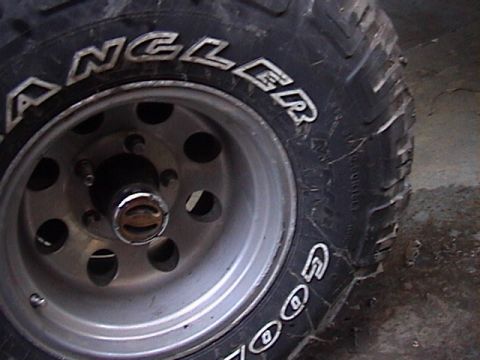 1990 Ford Bronco - Close-up of a tire and wheel assembly, likely from an off-road vehicle.