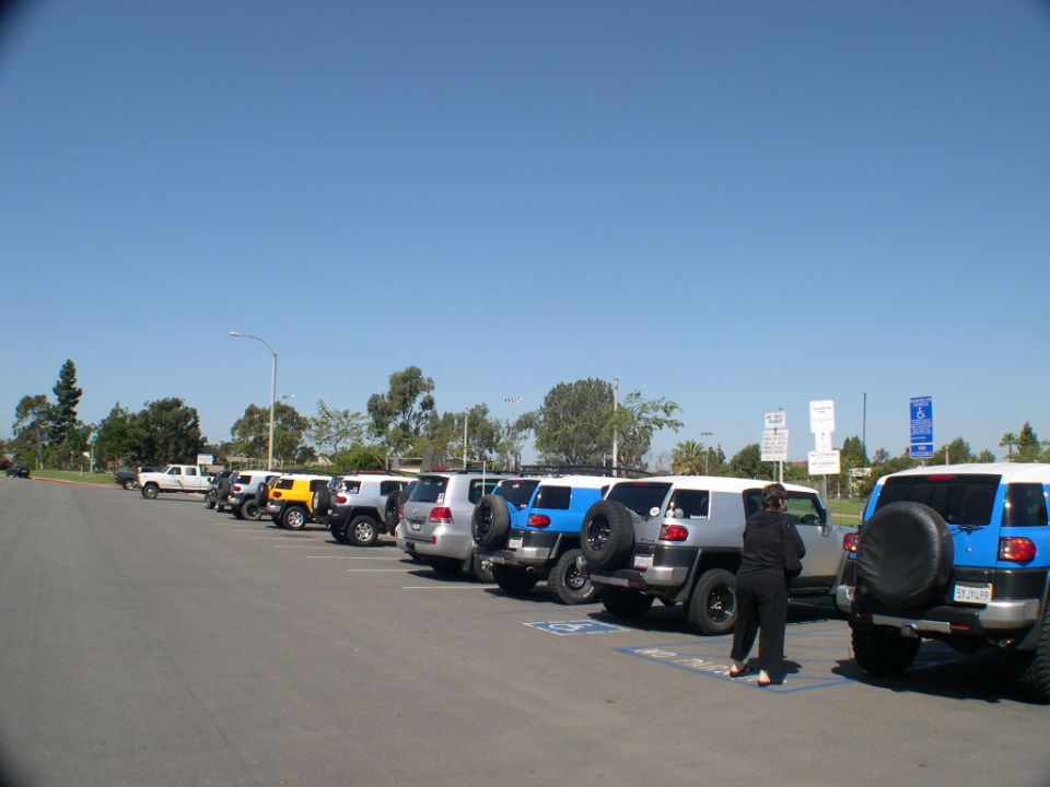 Silver and blue 2007 Toyota FJ Cruisers parked in a lot, rear view