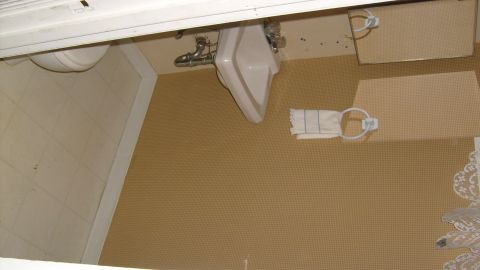 1995 Ford C-350 (Centurion Conversions) - Interior view of a bathroom with a sink, toilet, and towel holder.