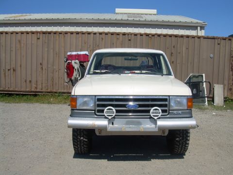 1991 Ford Bronco - Front view of a white 1991 Ford Bronco parked outdoors.