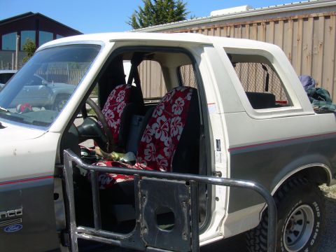 1991 Ford Bronco - This 1991 Ford Bronco shows its interior with custom seat covers and aftermarket roll cage installed.