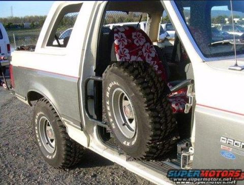 1991 Ford Bronco - Spare tire mounted inside the driver's side door opening of a 1991 Ford Bronco.