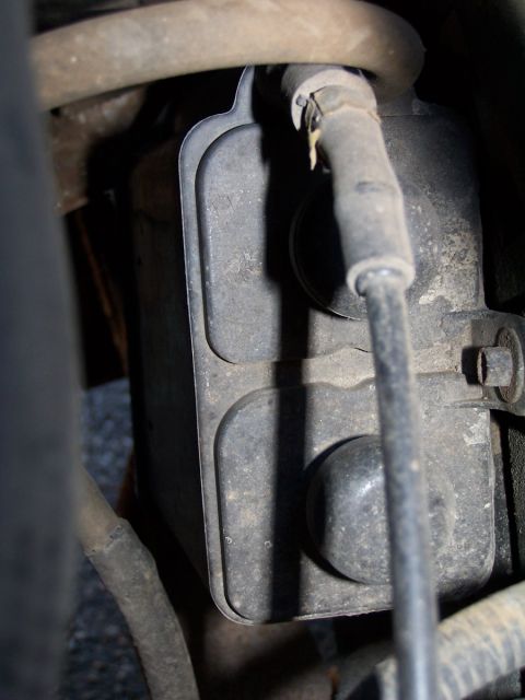 1990 Ford Bronco - Engine component with attached hoses, likely from a vehicle's under-hood area.