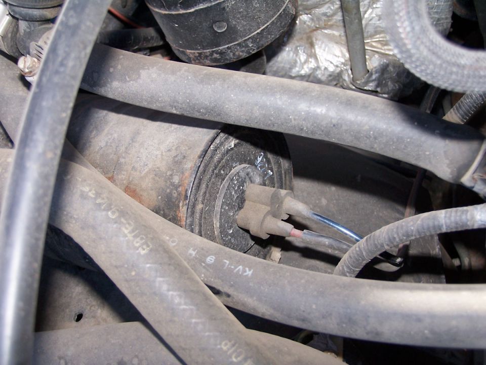 Engine part with electrical connector and hoses