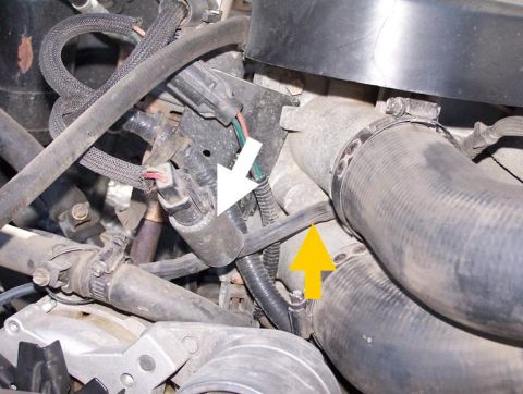1990 Ford Bronco - Close-up view of engine components, with arrows indicating specific parts within the engine bay.