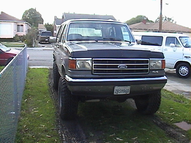 Lifted 1990 Ford Bronco front view with large tires