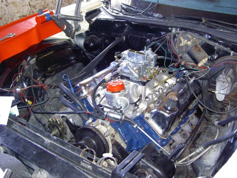 1972 Ford Ranchero - The engine bay shows a V8 engine with a carburetor and various hoses and wires.