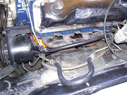 1972 Ford Ranchero - Close-up view of an engine bay chrome Edelbrock valve covers and blue painted intake manifold components.