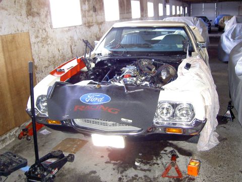 1972 Ford Ranchero - A white Ford vehicle, likely from the early 1970s, is parked in a garage with its engine exposed for maintenance.