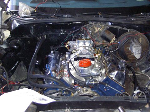 1972 Ford Ranchero - The engine bay shows a V8 engine with aftermarket chrome parts and a prominent carburetor.