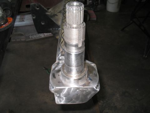 1989 Ford Bronco - Close-up view of a metal spindle assembly, likely a replacement part for a vehicle's drivetrain or suspension system.