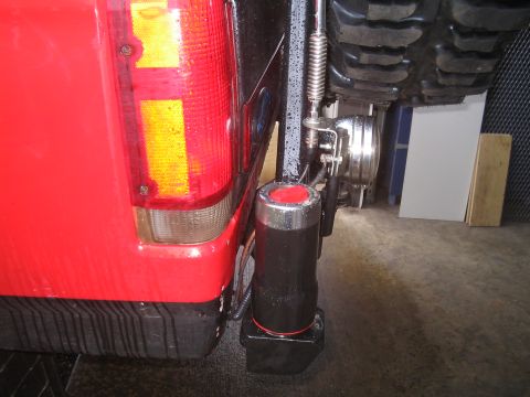 1989 Ford Bronco - The rear of a red SUV shows a spare tire mount and an auxiliary light attached to the bumper.