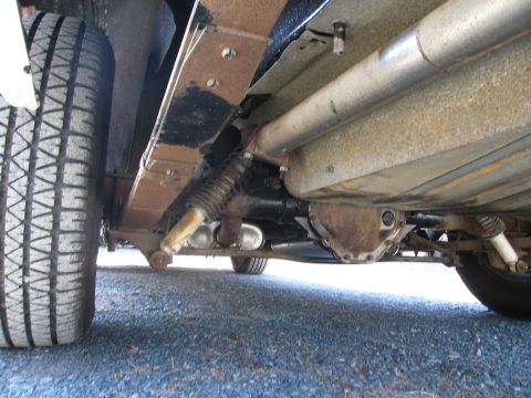 1991 Ford Crown Victoria LTD - Undercarriage view of a vehicle, focusing on suspension and drivetrain components.