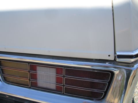 1991 Ford Crown Victoria LTD - Close-up of a car's rear end, showing the taillight and chrome bumper details.