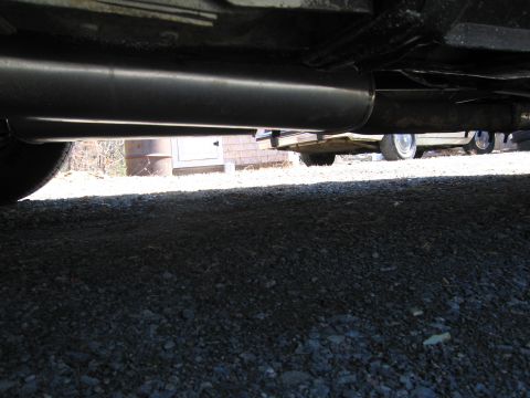 1991 Ford Crown Victoria LTD - Underside view of a vehicle's exhaust system, with a second vehicle partially visible in the background.