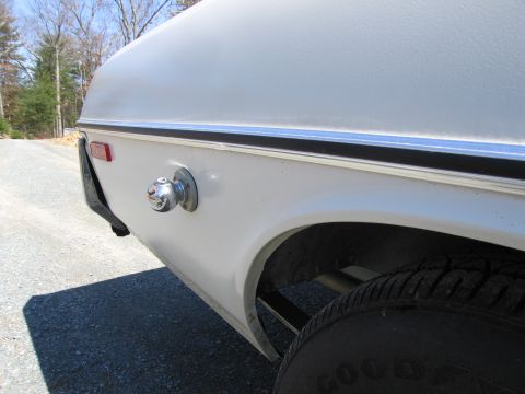 1991 Ford LTD Crown Victoria - Close-up of a trailer hitch ball mount attached to the rear quarter panel of a white vehicle.