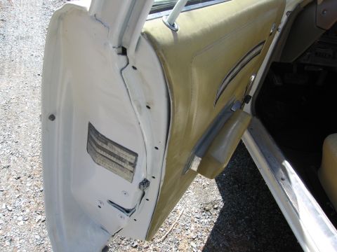 1991 Ford LTD Crown Victoria - Close-up view of the interior door panel and frame of a vehicle, with a visible sticker on the door jamb.