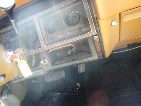 1991 Ford LTD Crown Victoria - The interior of a vehicle shows the dashboard with gauges, pedals, and exposed wiring, indicating a need for repair.