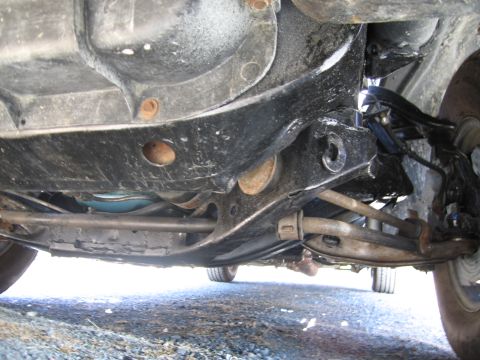1991 Ford LTD Crown Victoria - A view of the vehicle's undercarriage, showing suspension and frame details.