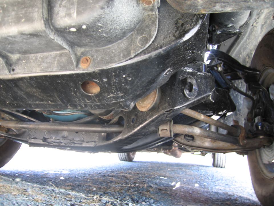 Undercarriage view of a vehicle's suspension and frame components