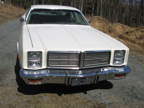 1991 Ford LTD Crown Victoria - Front view of a white sedan with a large chrome grille and dual headlights.