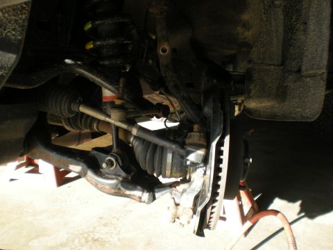 2007 Toyota Land Cruiser - Close-up view of vehicle's front suspension system, showing various mechanical components.