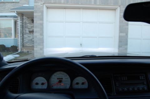 1985 Mercury Grand Marquis - Interior view of a car showing the dashboard and a garage door.