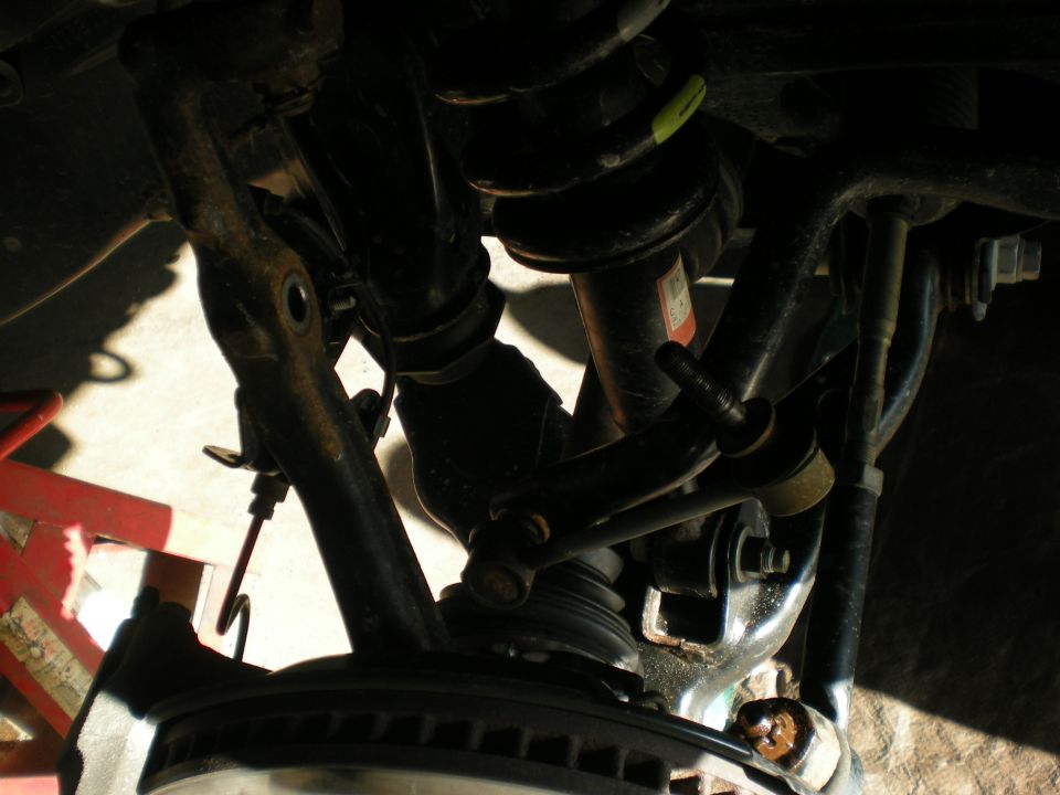 Suspension components with a red jack stand visible