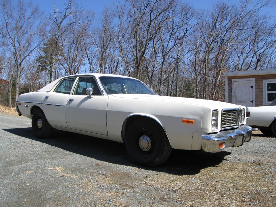 White 1977 Dodge Monaco sedan parked outside on a gravel lot