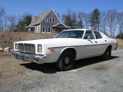 1991 Ford LTD Crown Victoria - A white sedan is parked on a gravel driveway in front of a house.
