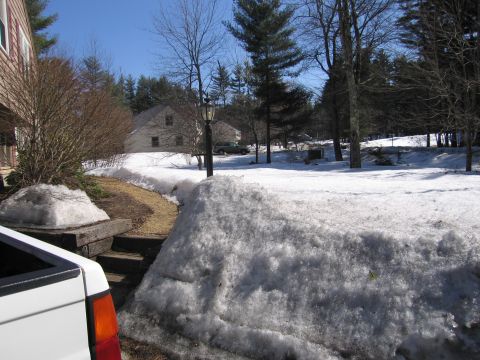 1991 Ford LTD Crown Victoria - A winter scene with snowdrifts, houses, and trees under a clear blue sky.
