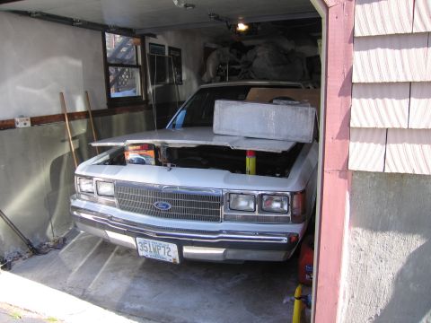 1991 Ford LTD Crown Victoria - A 1991 Ford Crown Victoria LTD is parked in a garage with its hood open, revealing the engine compartment.