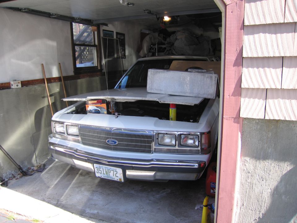 White 1991 Ford Crown Victoria LTD with hood open in a garage. License plate 351WP72