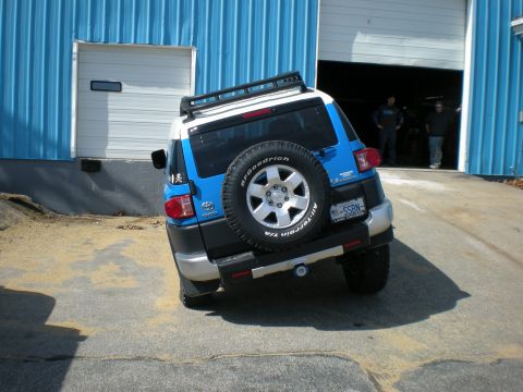 2007 Toyota Land Cruiser - The rear of a two-tone Toyota FJ Cruiser is visible as it is parked near a garage entrance.