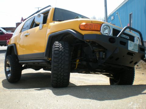 2007 Toyota Land Cruiser - Yellow 2007 Toyota FJ Cruiser SUV with aftermarket bumper and off-road tires.