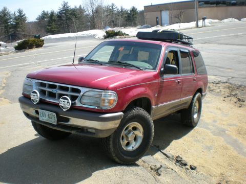 2007 Toyota Land Cruiser - This lifted Ford Explorer is equipped with auxiliary lights and a roof rack for outdoor adventures.
