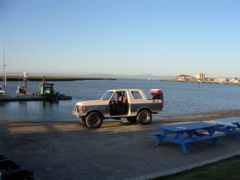 1991 Ford Bronco - This 1991 Ford Bronco is parked near a harbor with its doors open, ready for an adventure.