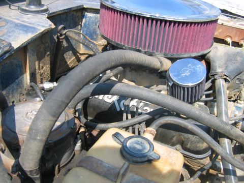 1992 Ford Mustang - Close-up of an engine bay showing an aftermarket air intake system and various hoses.