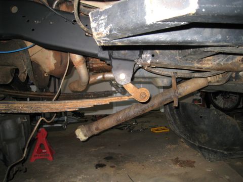 1996 Ford Bronco - Undercarriage view of a vehicle, focusing on suspension and exhaust system components.