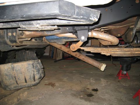 1996 Ford Bronco - The undercarriage of a vehicle is shown, with focus on the suspension and exhaust system.