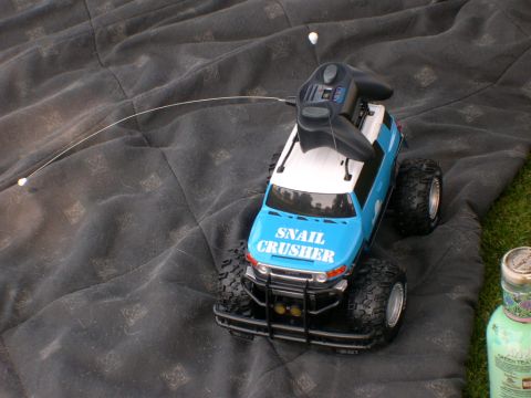 2007 Toyota FJ Cruiser - A remote control toy truck with a controller on top is placed on a dark blanket.