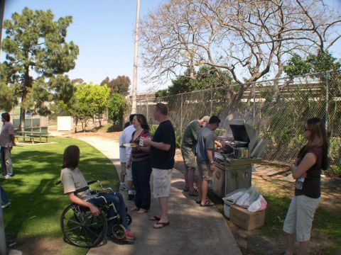 2007 Toyota FJ Cruiser - A group of people enjoy a barbecue outdoors on a sunny day.