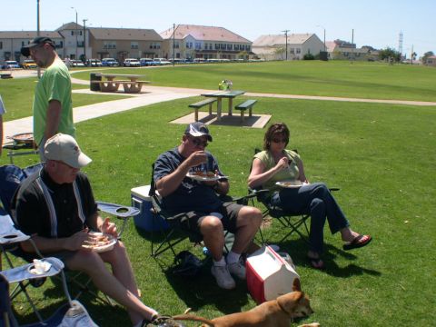 2007 Toyota FJ Cruiser - A group of people relax and eat at a picnic in a park on a sunny day.