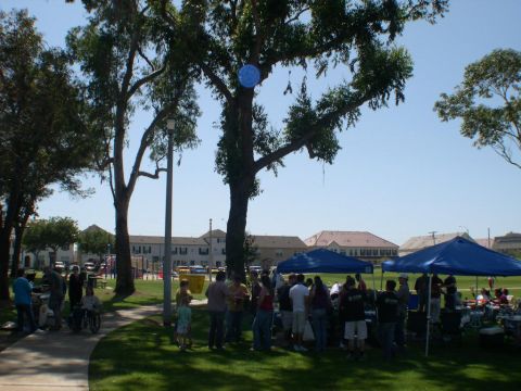 2007 Toyota FJ Cruiser - An outdoor event with people mingling under blue tents on a sunny day.