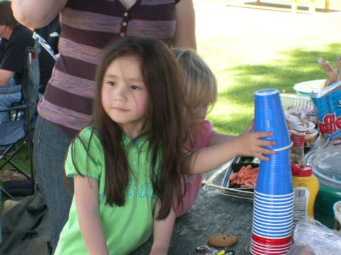2007 Toyota FJ Cruiser - Children play with stacked cups and food at an outdoor picnic.
