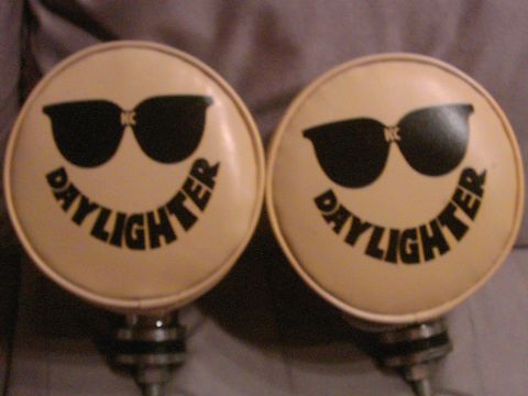 1987 Ford Bronco - KC Daylighter driving lights with sunglasses and smiley face graphics are shown.