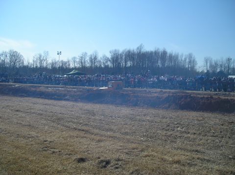1993 Ford Bronco - A large crowd watches an event unfold in an open field under a clear blue sky.